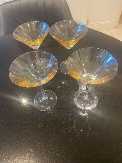 Set of four amber and plain glass martini or cocktail glasses