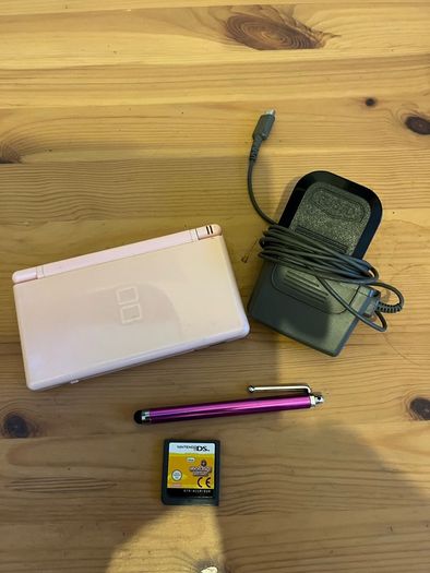 Pink Nintendo DS lite with charger and games