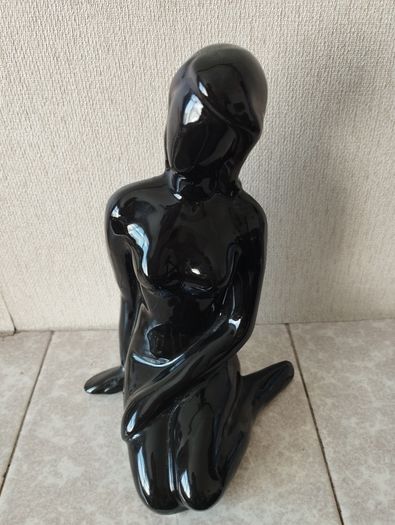 Vintage statue of a seated woman, nude figure, ceramic, glossy black.