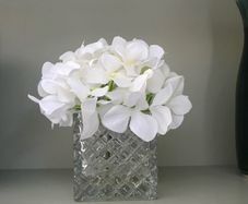 artifical white hydrangea flower and glass vase