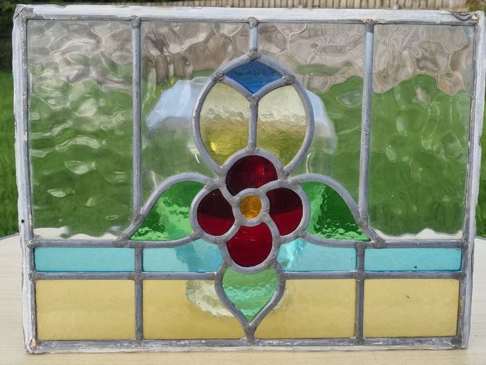 Antique leaded stained-glass panel in the Art Nouveau style.