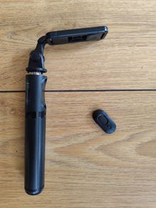 black extendable selfie stick and mini-tripod featuring a detachable wireless Bluetooth remote.