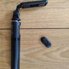 black extendable selfie stick and mini-tripod featuring a detachable wireless Bluetooth remote.