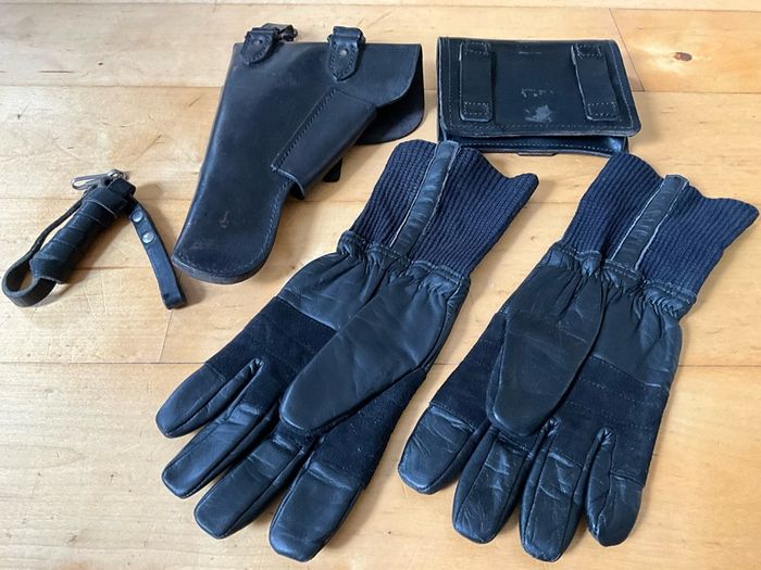 Vintage military-style black leather gear, likely representing a pistol holster, ammunition pouch