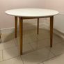Round dining table with four grey fabric chairs Image 3