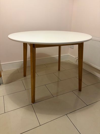 Round dining table with four grey fabric chairs
