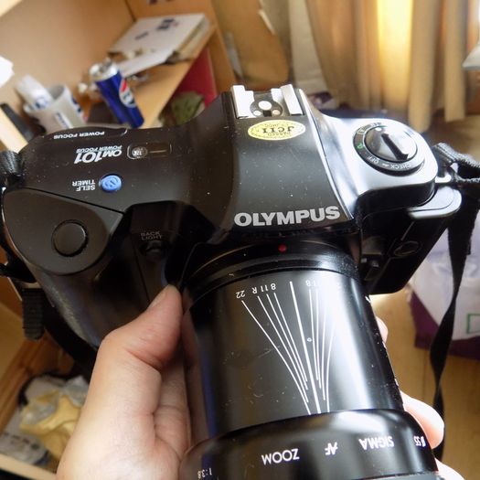 Old heavy Olympus OM101 Camera with lens.