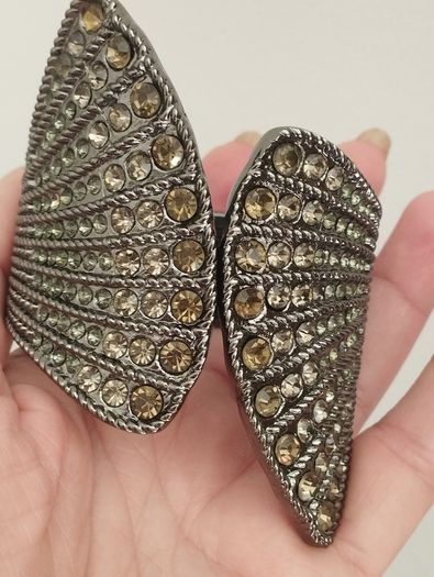 A striking wide bracelet encrusted with sparkling rhinestones.