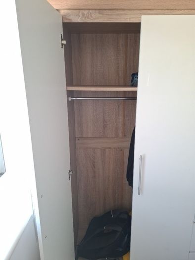 Timer and white wardrobe and bedside locker
