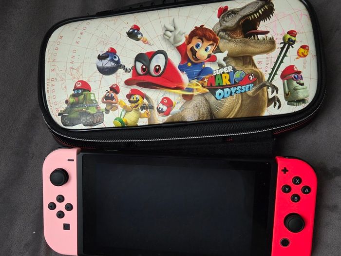Nintendo Switch with original case and Anker adapter.