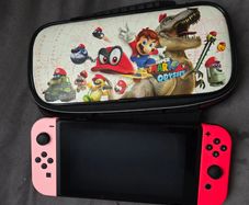 Nintendo Switch with original case and Anker adapter.