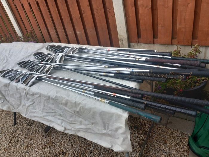 A selection of golf clubs and bags. Golf balls