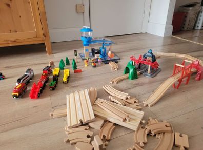 wooden train play set with two electric locomotives and lots of parts
