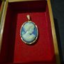 Vintage Cameo Goldtone Pendant on a Blue Background Image 3