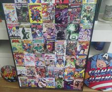 large wooden framed super heroes and villans wall hanging and 2 metal wallhanging discs