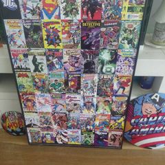 large wooden framed super heroes and villans wall hanging and 2 metal wallhanging discs