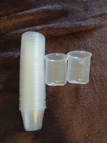 56 measuring cups for medication, brand new