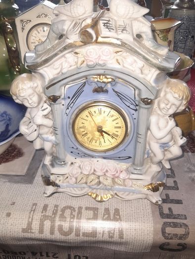 Porcelain Mantel Clock with Two Cherubs and Two Doves on top, and floral accents, Postage Available