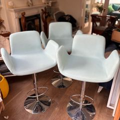 Three aqua blue armchair-style designer barstools by Decoronline