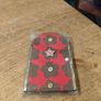 handcrafted wooden  Fairy door with red cardstock, brown flower cutouts, and decorative buttons.  various buttons acting as handles or embellishments. Image 2