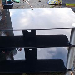 Black glass TV stand with silver legs