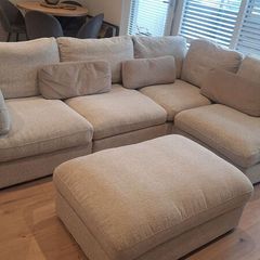 Corner sofa (either corner) with storage ottoman.