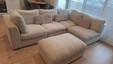 Corner sofa (either corner) with storage ottoman.