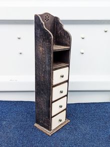 Small vintage wooden storage unit with heavy ceramic drawers with brass knobs
