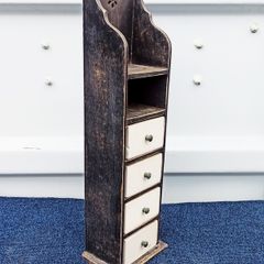 Small vintage wooden storage unit with heavy ceramic drawers with brass knobs