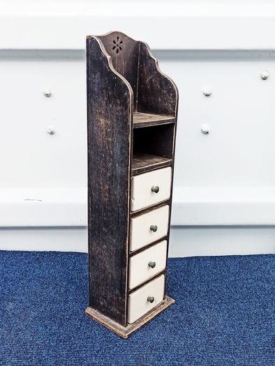 Small vintage wooden storage unit with heavy ceramic drawers with brass knobs