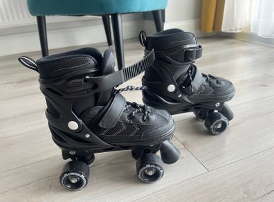 Power adjustable black quad roller skates