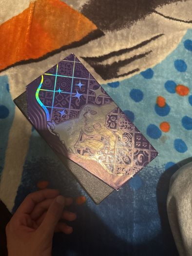 pokemon cards and book and sleeves and game thing