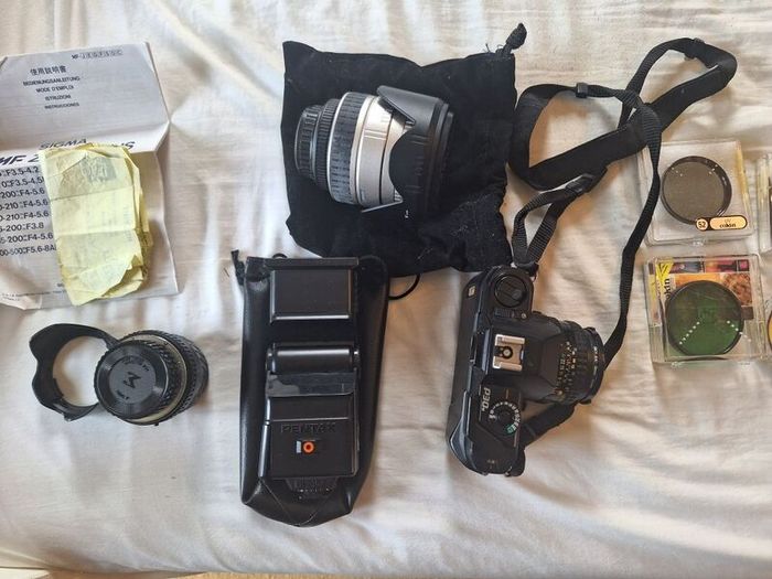 canon camera and pro lenses and a Pentax film system