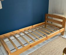 Single slatted wooden bed