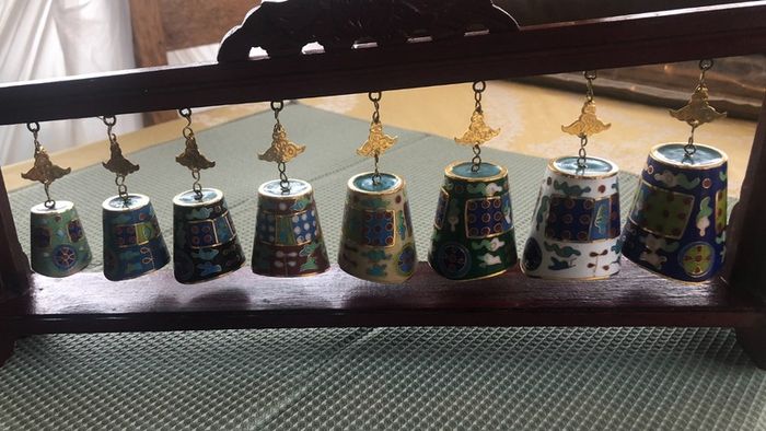 Enamel cloisonne graduated bells on wooden stand