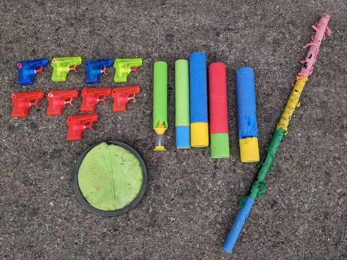 Kids water guns, soakers,a pinata stick and a scatch catcher