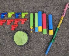 Kids water guns, soakers,a pinata stick and a scatch catcher