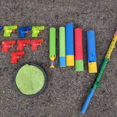 Kids water guns, soakers,a pinata stick and a scatch catcher