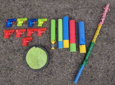 Kids water guns, soakers,a pinata stick and a scatch catcher
