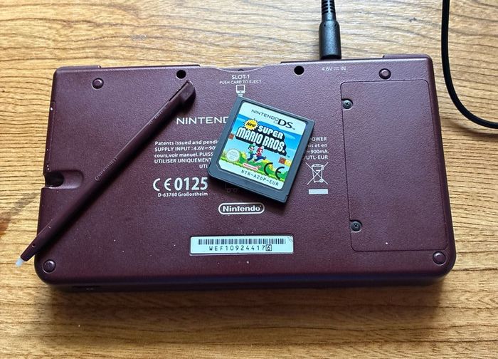 Nintendo DSi XL burgundy with Super Mario
