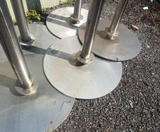 Stainless steel barrier posts for queue management with heavy duty bases for stability. The tops have fitting for ropes or belts to be attached between them.