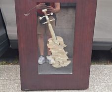 Handcrafted encased iron violin (case slightly damaged)