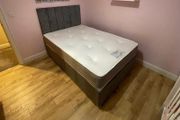 Grey double bed with mattress