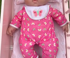 Baby doll with pink onesie EUC