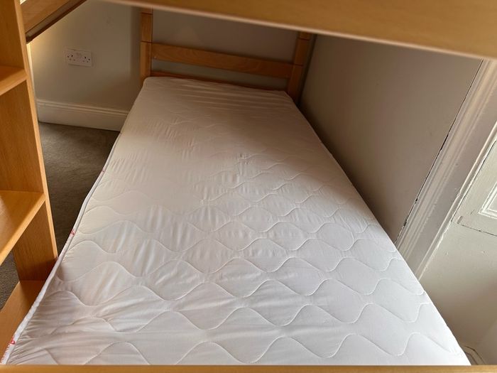 Bunk bed with attached slide and mattresses