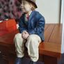 Resin sculpture of a seated boy Image 4