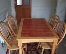 Pine dining table with tiled top and four chairs
