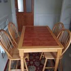 Pine dining table with tiled top and four chairs