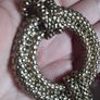 Vintage necklace with a pendant in the form of a ring and links in the form of a snake in gold tone. Image 3