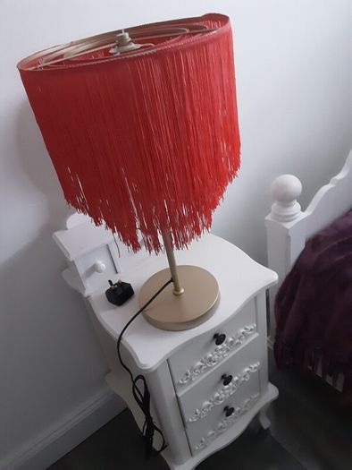 Orange fringed lamp on bass base